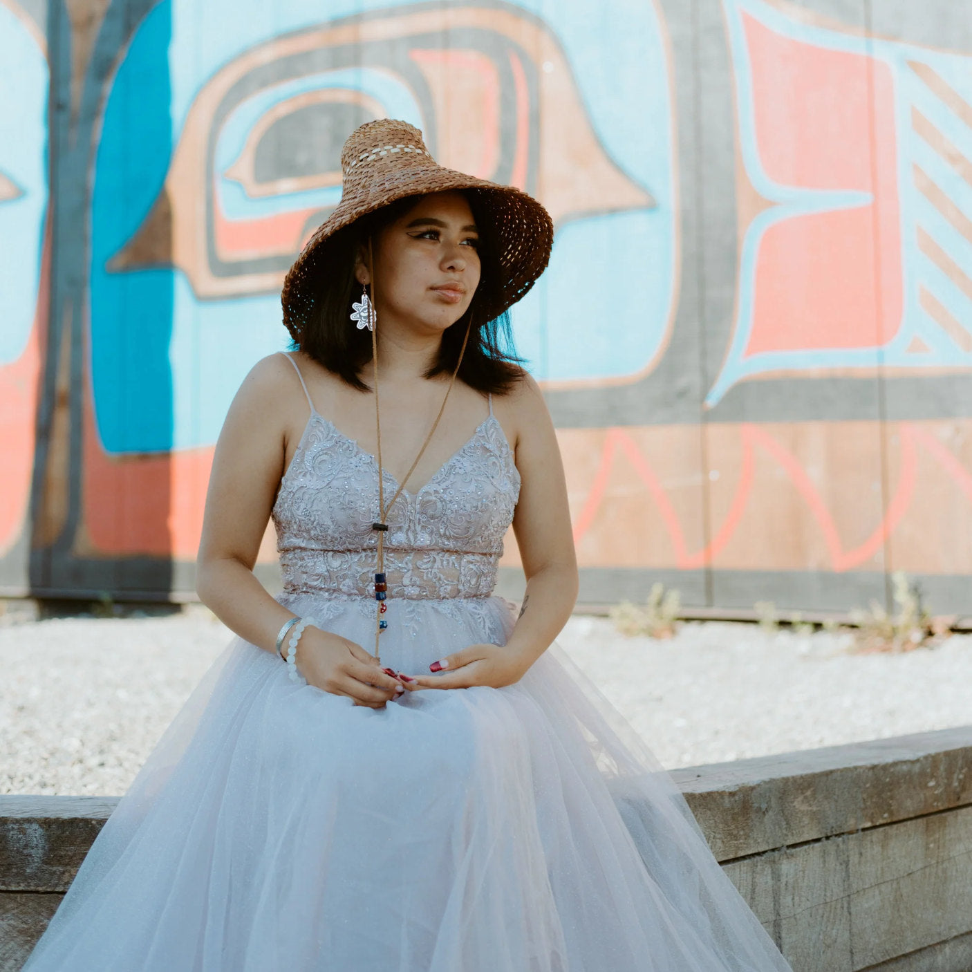 A model wearing rose gold mirror acrylic "Balance Sun" earrings from Copper Canoe Woman.