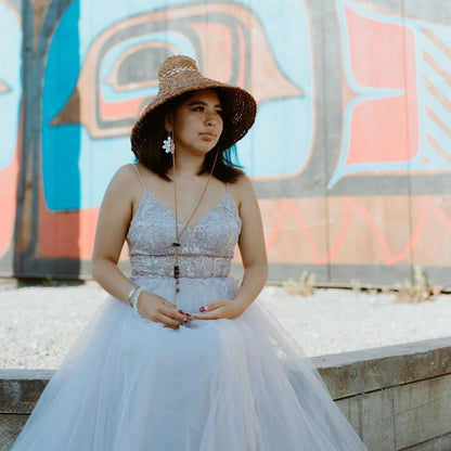 A model wearing rose gold mirror acrylic "Balance Sun" earrings from Copper Canoe Woman.