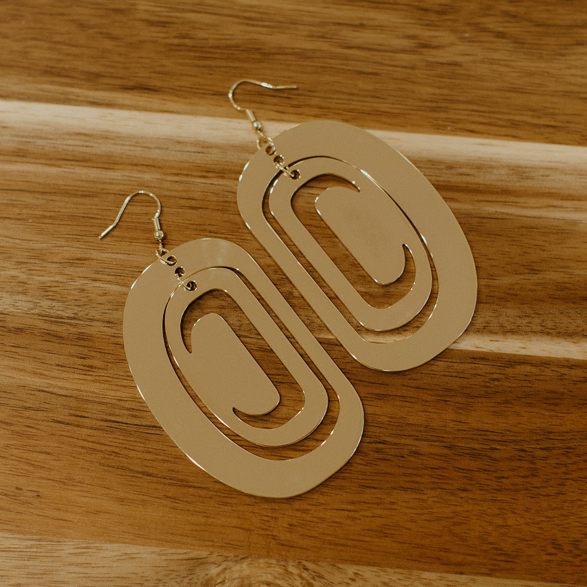 large ovoid earring gold metal crescent cutout