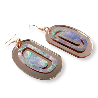 A pair of "Abalone Ovoid" earrings in rose gold mirror acrylic from Copper Canoe Woman.
