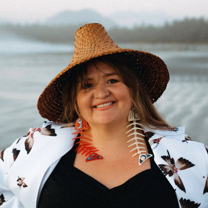 Model wearing one red and one ivory large salmon ghost earrings in acrylic from Copper Canoe Woman.