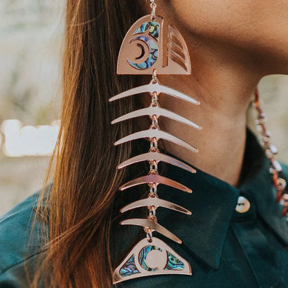 Copper Canoe Woman large salmon ghost earrings in rosegold mirror acrylic worn by a model.