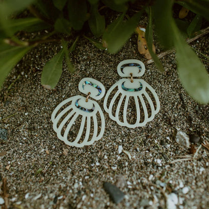 A pair of "Shell Woman" earrings from Copper Canoe woman in ivory acrylic.