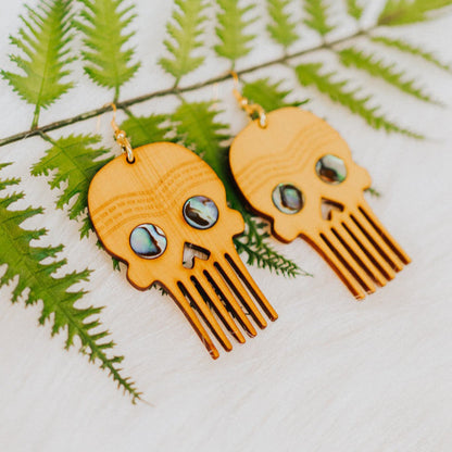 A pair of cedar Skull Comb earrings from Copper Canoe Woman.